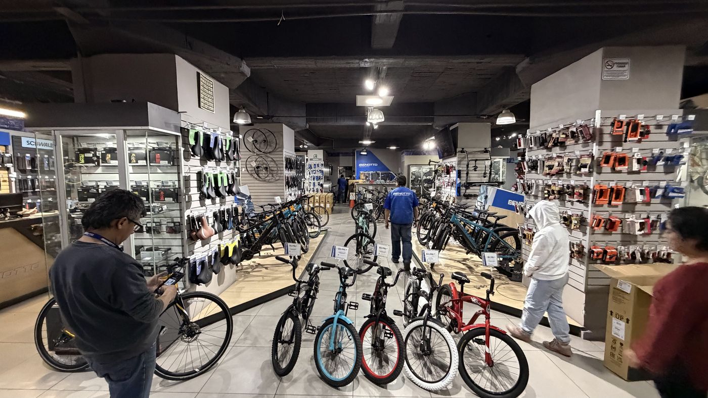 A crowded sales floor with bikes and accessories