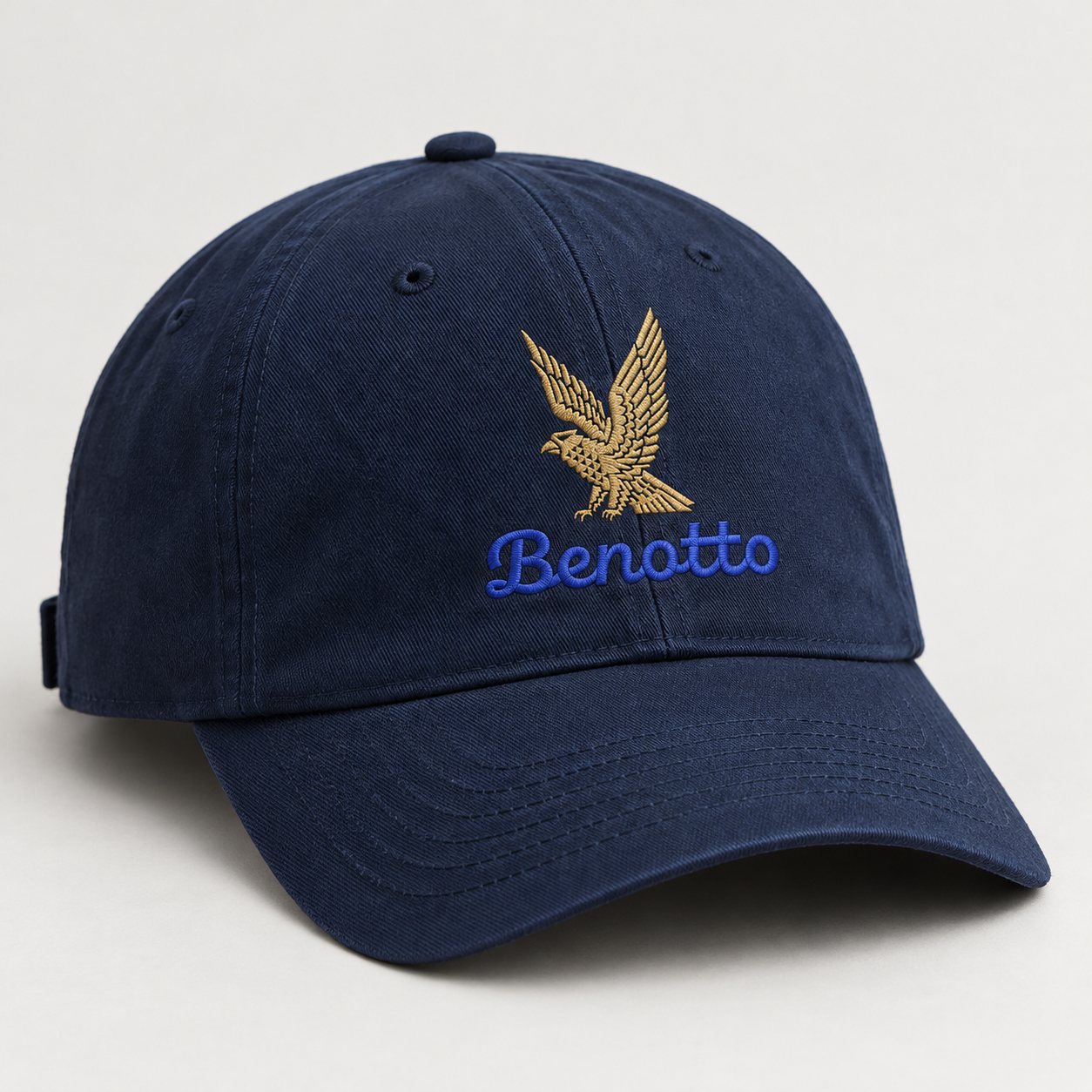 Navy cap with the gold eagle and the blue script wordmark embroidered