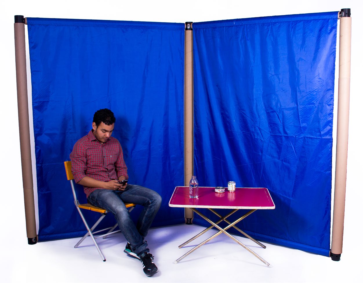 Screen module prototype enclosing a seated person with a small table